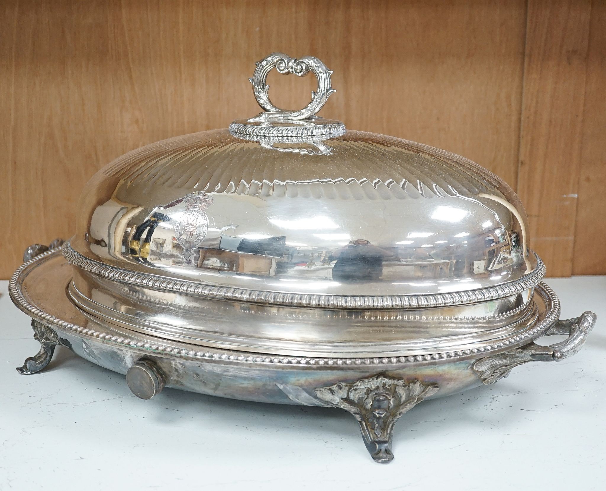 Two Victorian electroplate meat domes, and a hot water meat dish, 62 cms wide including handles.